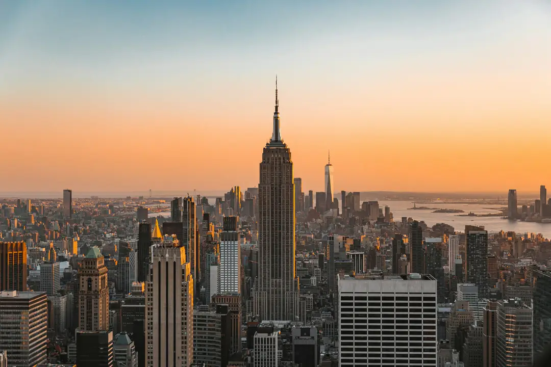 Midtown Manhattan and the Empire State Building under a soft orange sunset