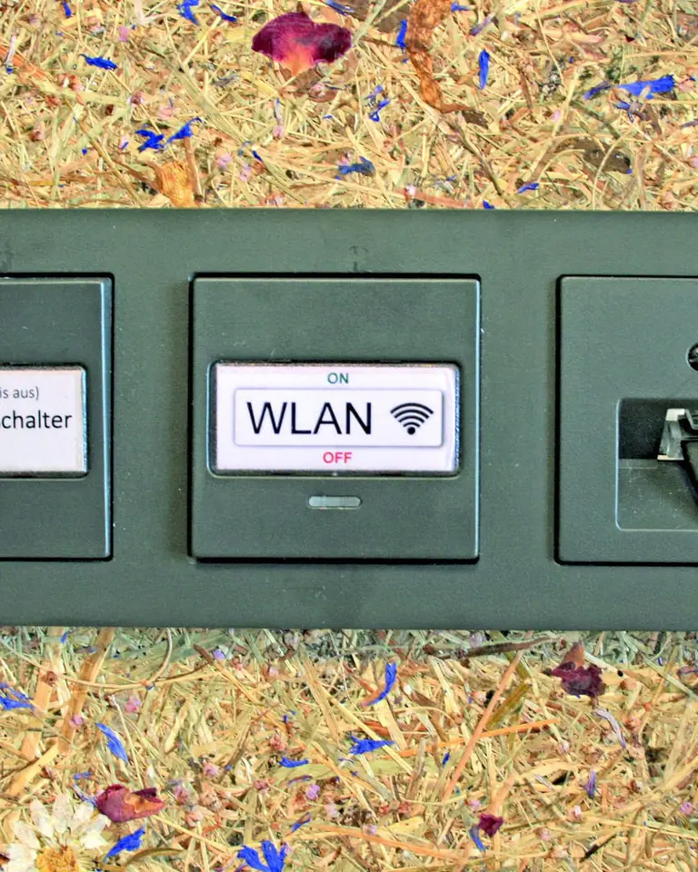Wall panel in a guest room with a good-night switch that cuts the circuit and a Wi-Fi on/off switch