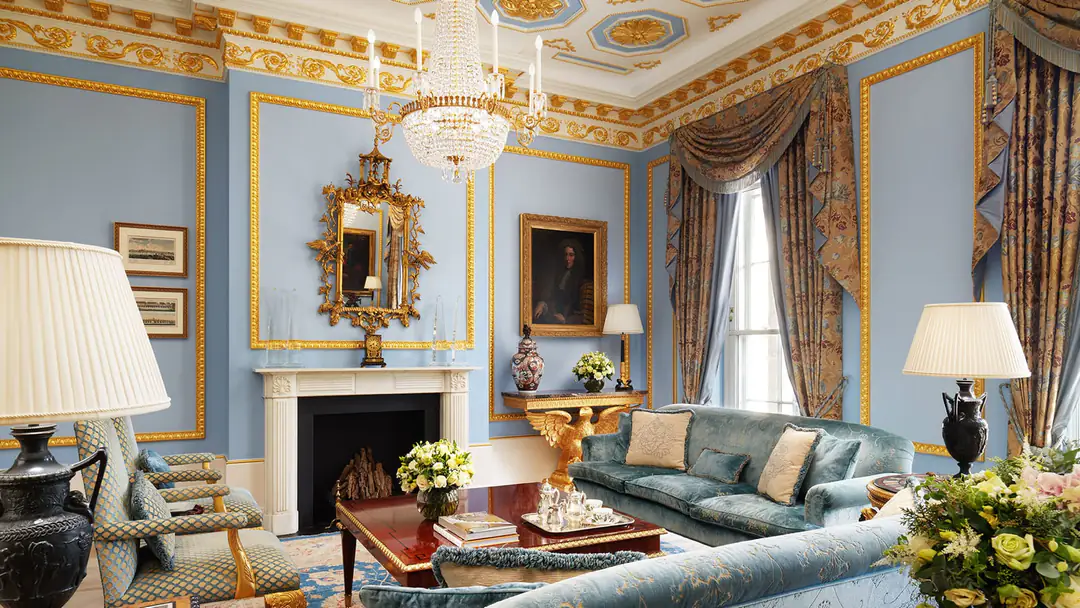 Pale blue Royal Suite drawing room with gilded mouldings, crystal chandelier, marble fireplace and velvet sofas